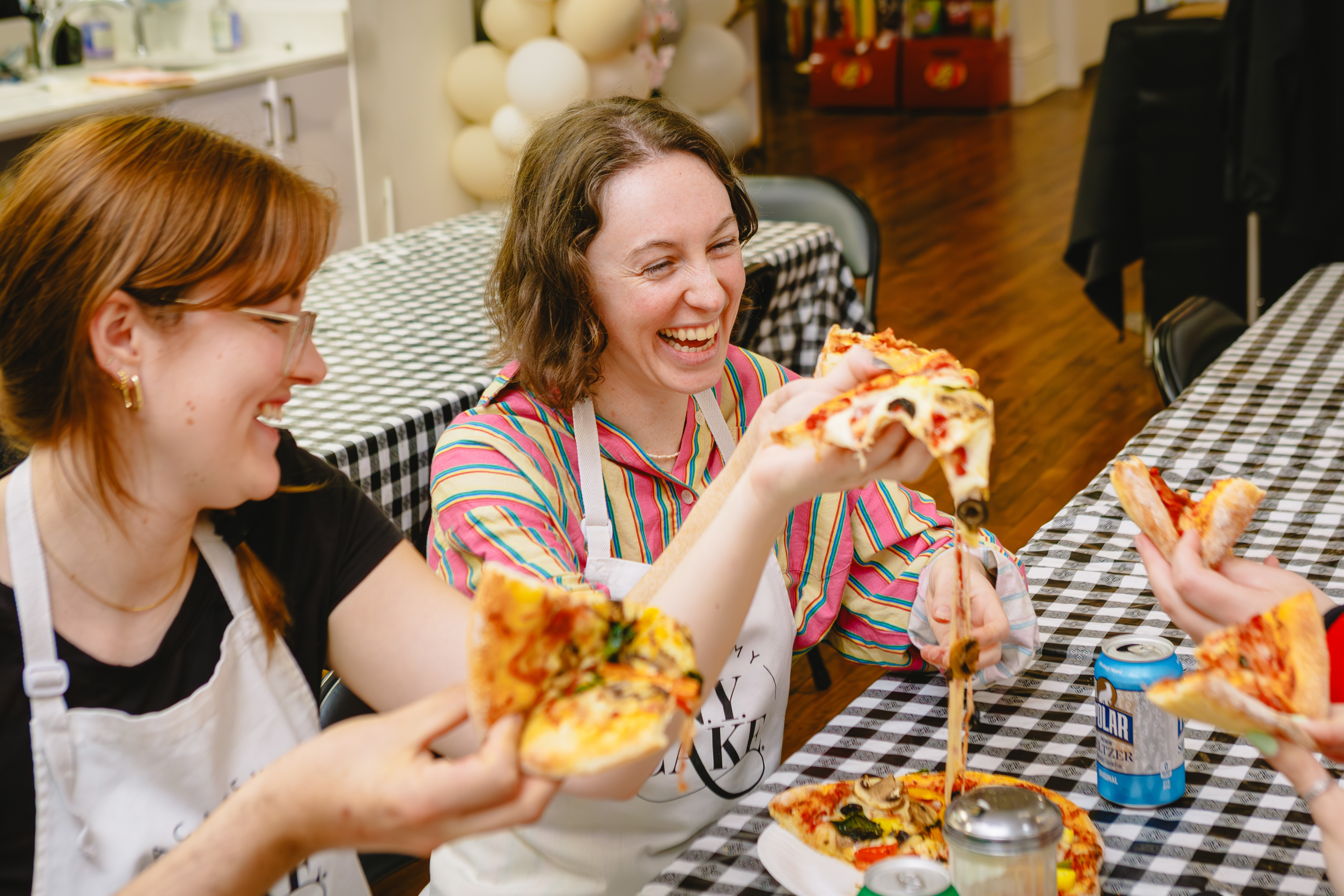 Two students enjoying a pizza together after a pizza making class